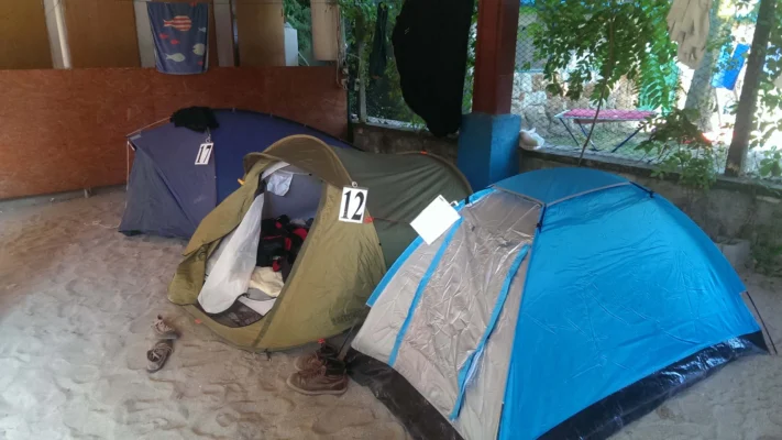 A bunch of tents inside someone's yard.