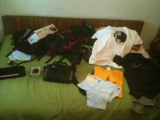 Clothes on a green sheet bed.