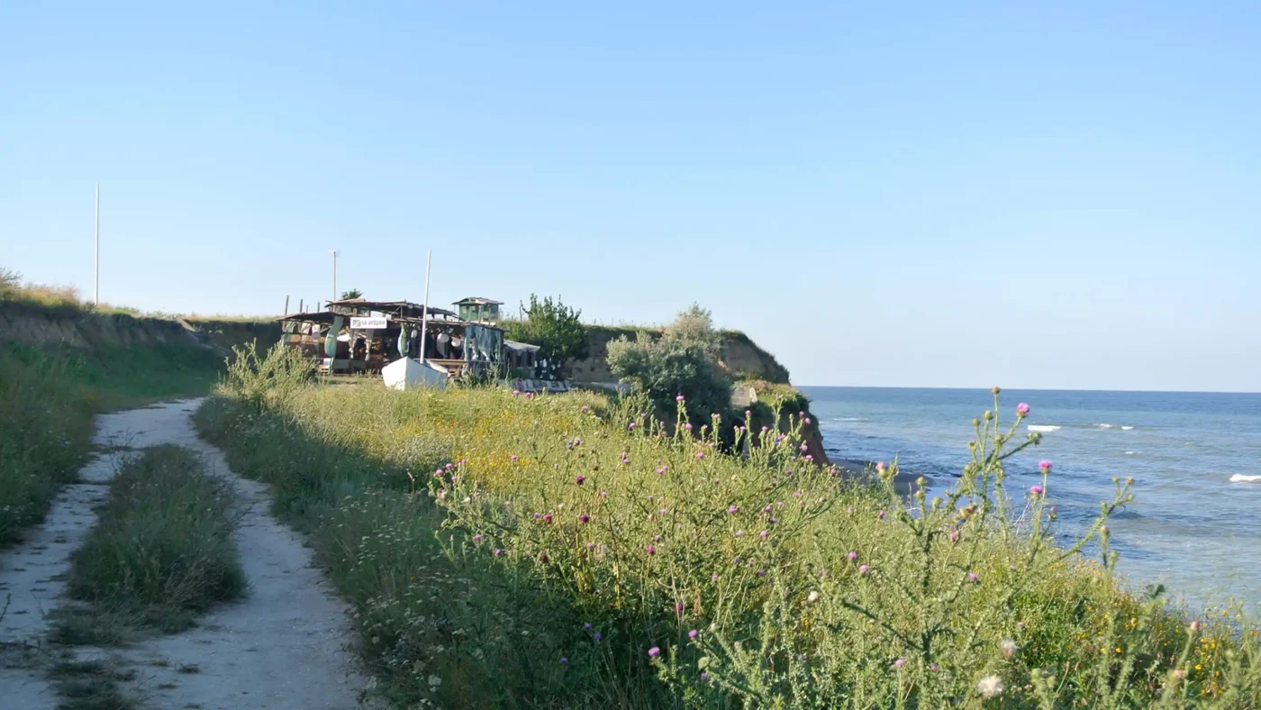 A bar shaped like a ship sitting on the edge of the Vama Veche cliffs, overlooking the Black Sea.