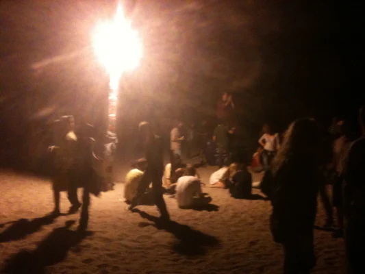 Huge crowd of people partying on the beach.