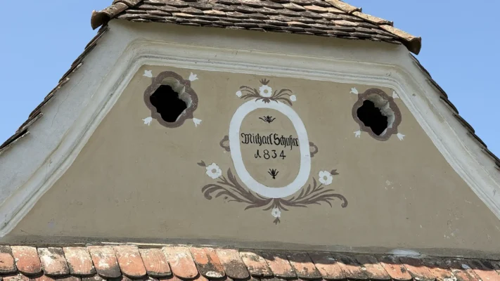 Decorated gable of a traditional Viscri house bearing the name Michael Schuster and the year 1834.