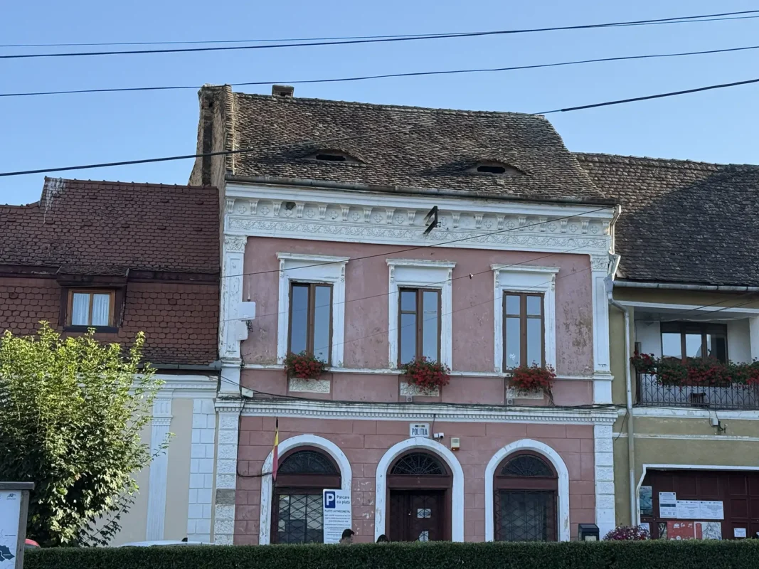Biertan police station with traditional eyebrow dormers resembling eyes in its tiled roof