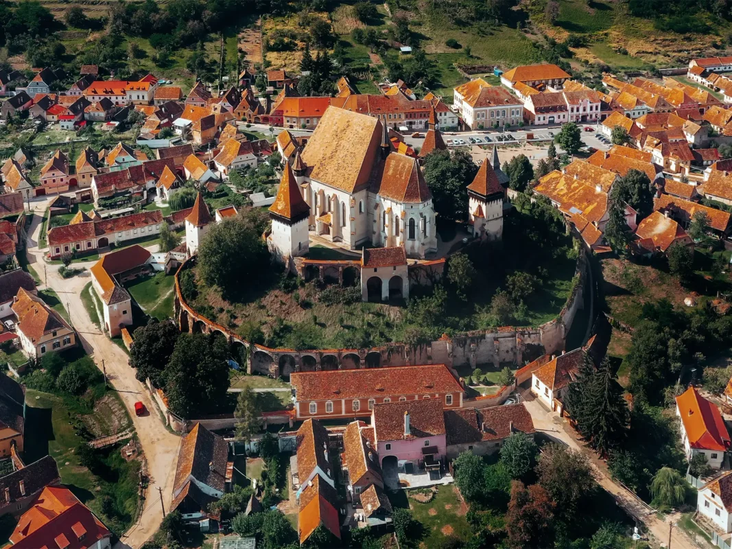 Aerial view of Biertan fortified church surrounded by the historic Saxon village in Transylvania