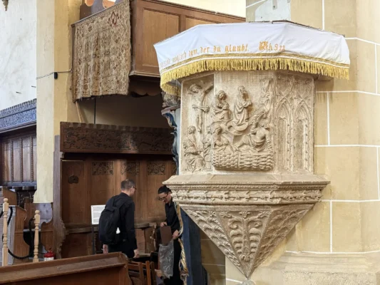 Ornately carved stone pulpit inside Biertan fortified church