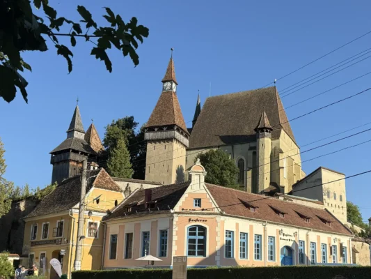 Clock Tower of Biertan fortified church overlooking the Saxon village and surrounding hills