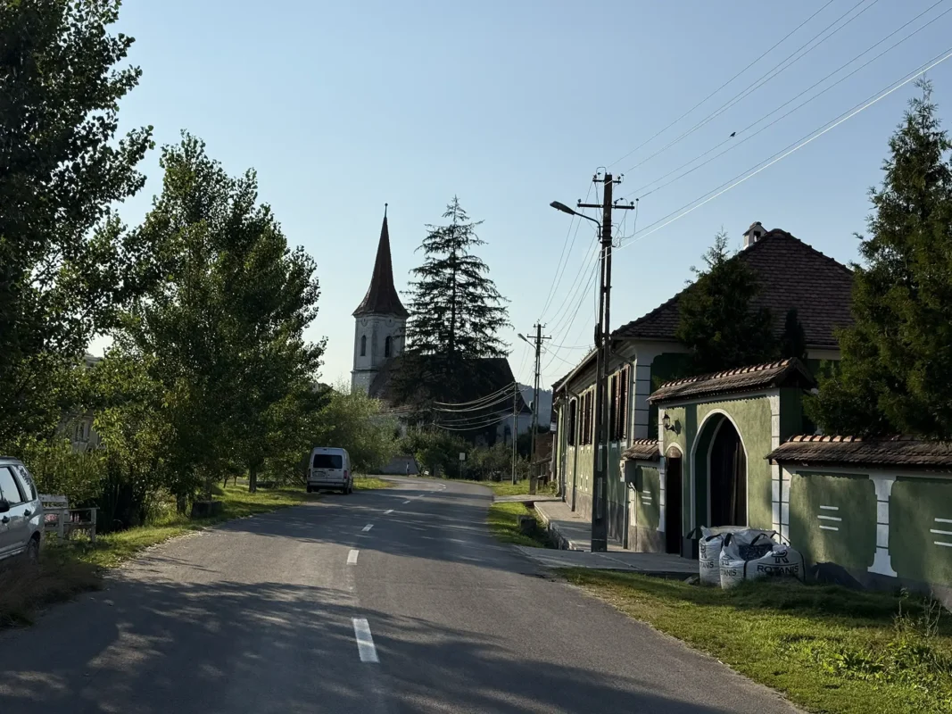 Reussdorfer Hof on the main street of Cund, a large green-painted Saxon house with the village church visible ahead.