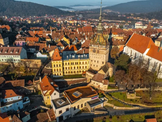 Aerial view of Sighișoara Citadel with the medieval Clock Tower and historic old town in Transylvania