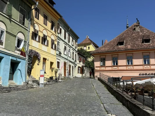 Steep cobblestone street and colourful historic houses inside Sighișoara Citadel