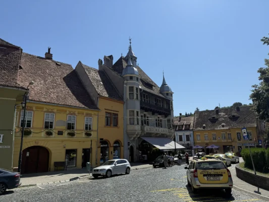 Historic buildings and cobblestone street below Sighișoara Citadel in Transylvania