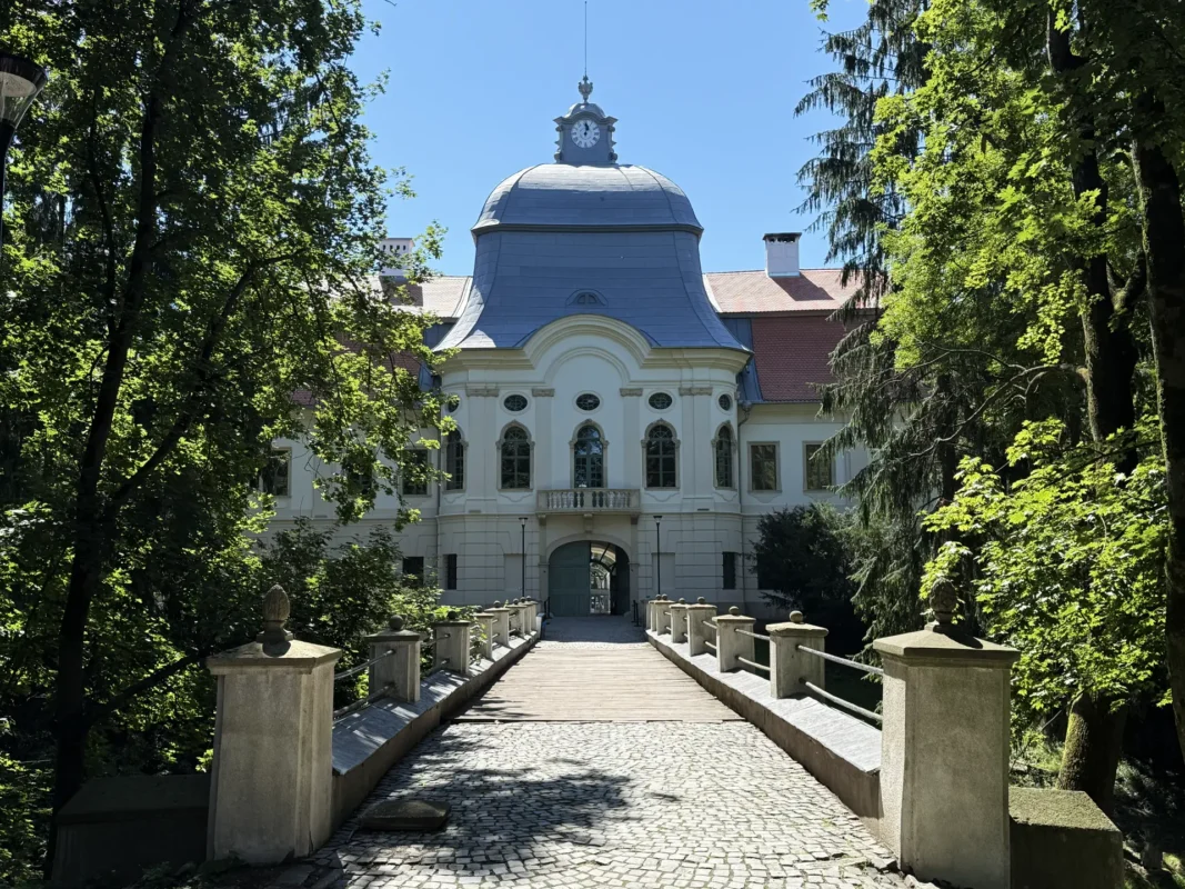 Teleki Castle in Gornești, Transylvania, viewed across the bridge through its historic park.